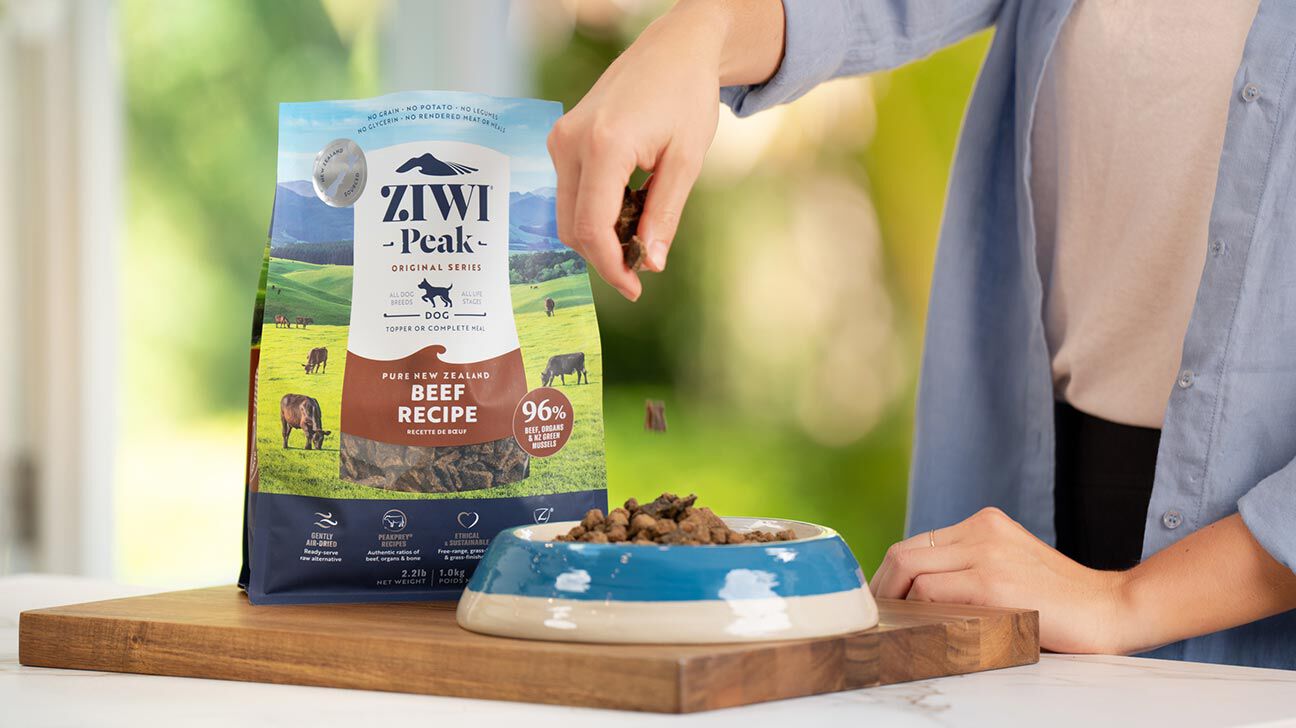 person pouring ZIWI Peak Beef Recipe into food bowl
